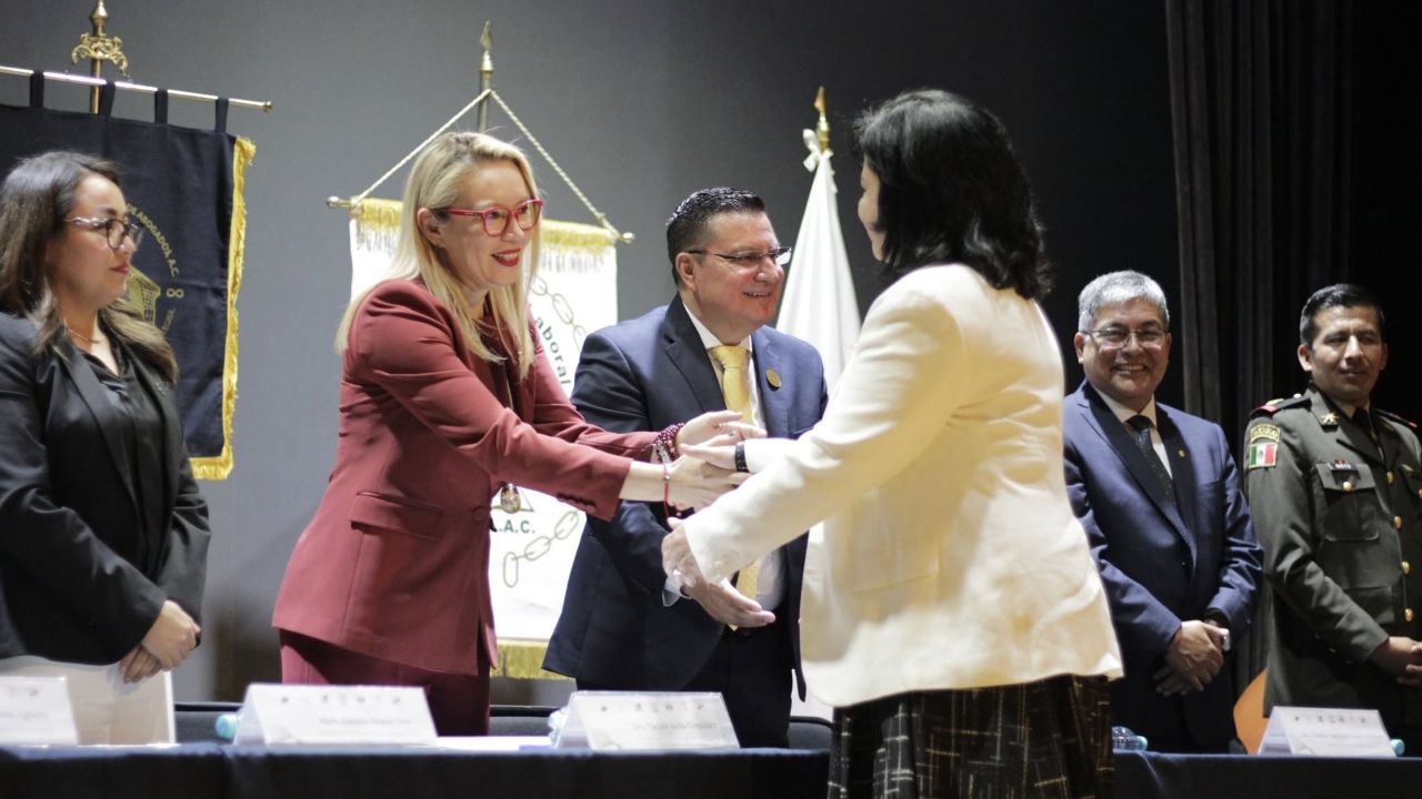 La rectora Yarabí Ávila González (de traje guinda) saluda a los miembros del presídium en el intercambio de felicitaciones con los representantes de los poderes judiciales. La rectora Yarabí Ávila González (de traje guinda) saluda a los miembros del presídium en el intercambio de felicitaciones con los representantes de los poderes judiciales.